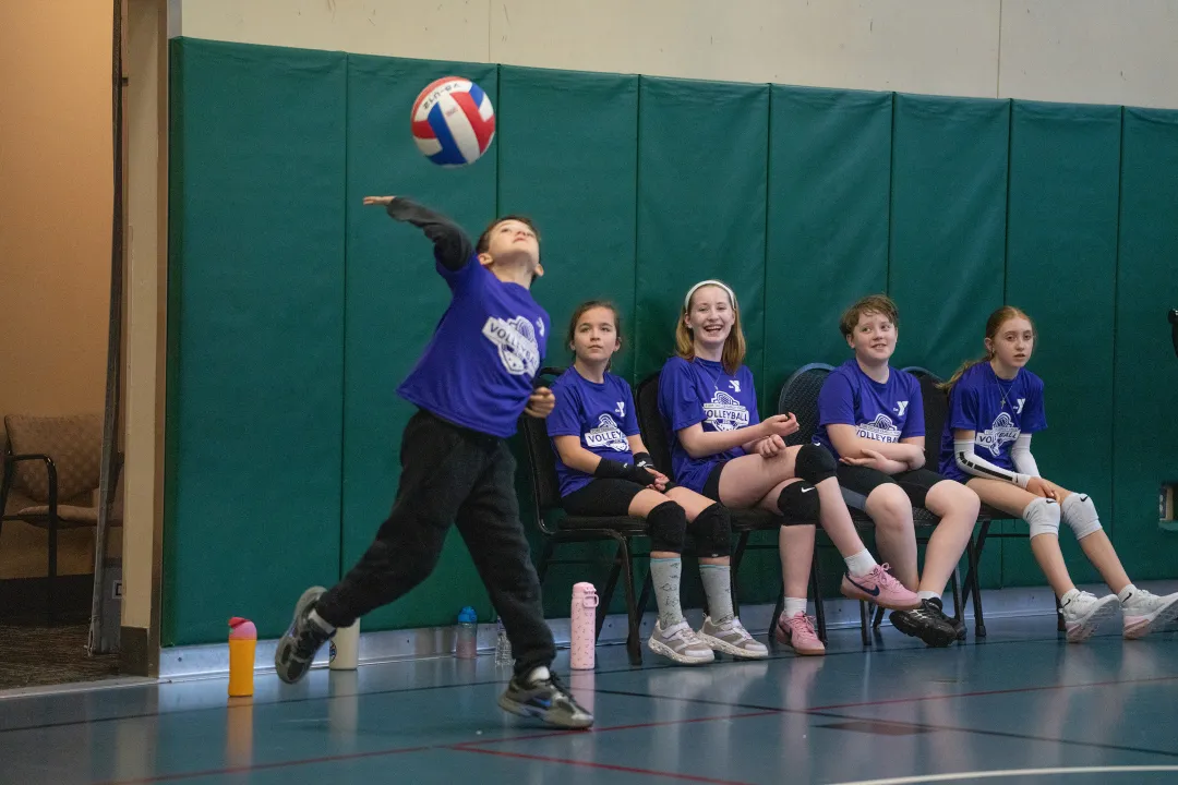 Boy Overhand Serving at YMCA Youth Volleyball Game